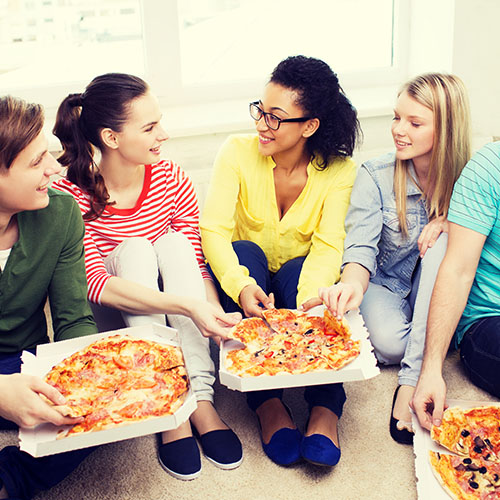 Friends enjoying delivery pizza. 