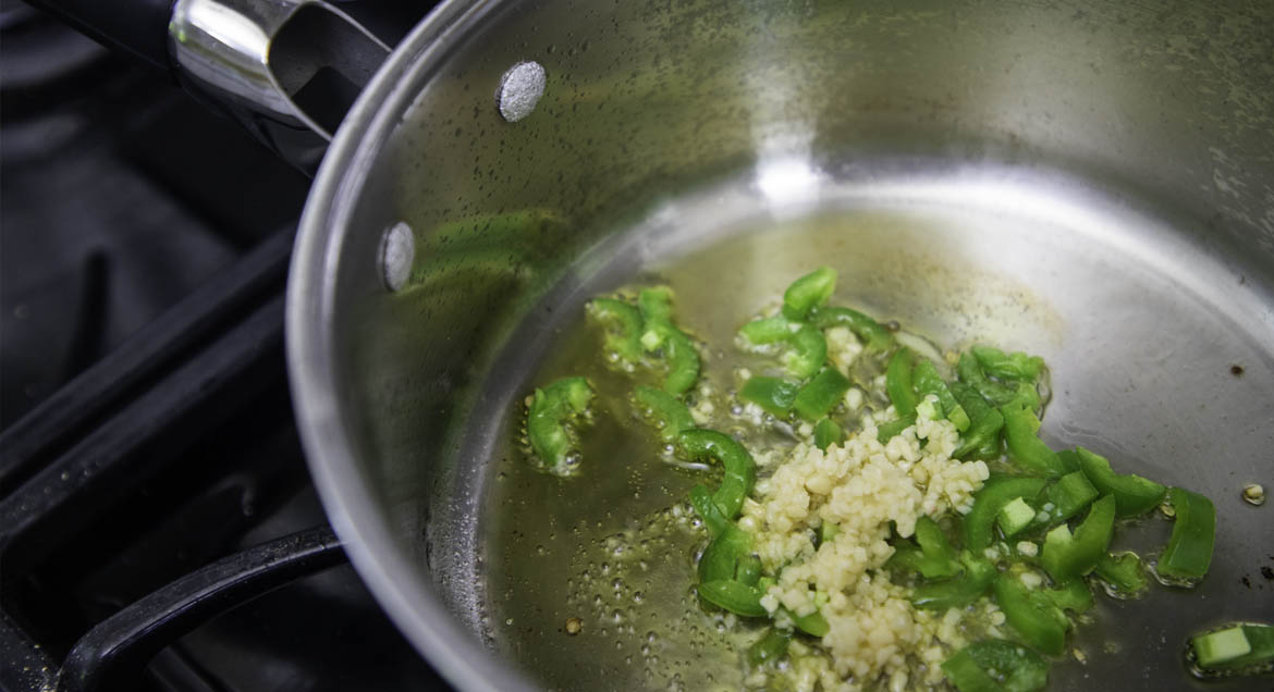 Jalapeños And Garlic In Frying Pan For Tofu Sofrita Tacos.