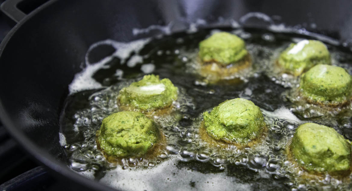 Falafel Balls Cooking In Cast Iron Wok.