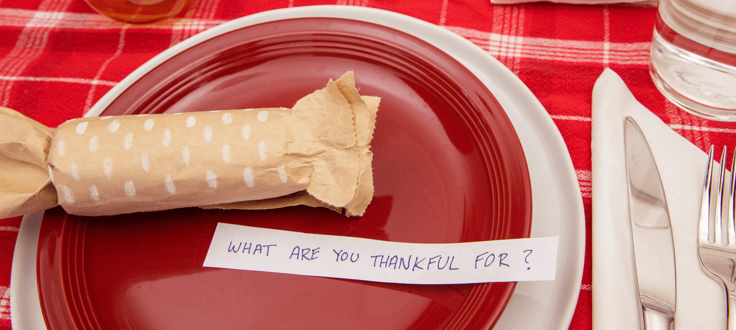 What are you thankful for message on top of a red plate.