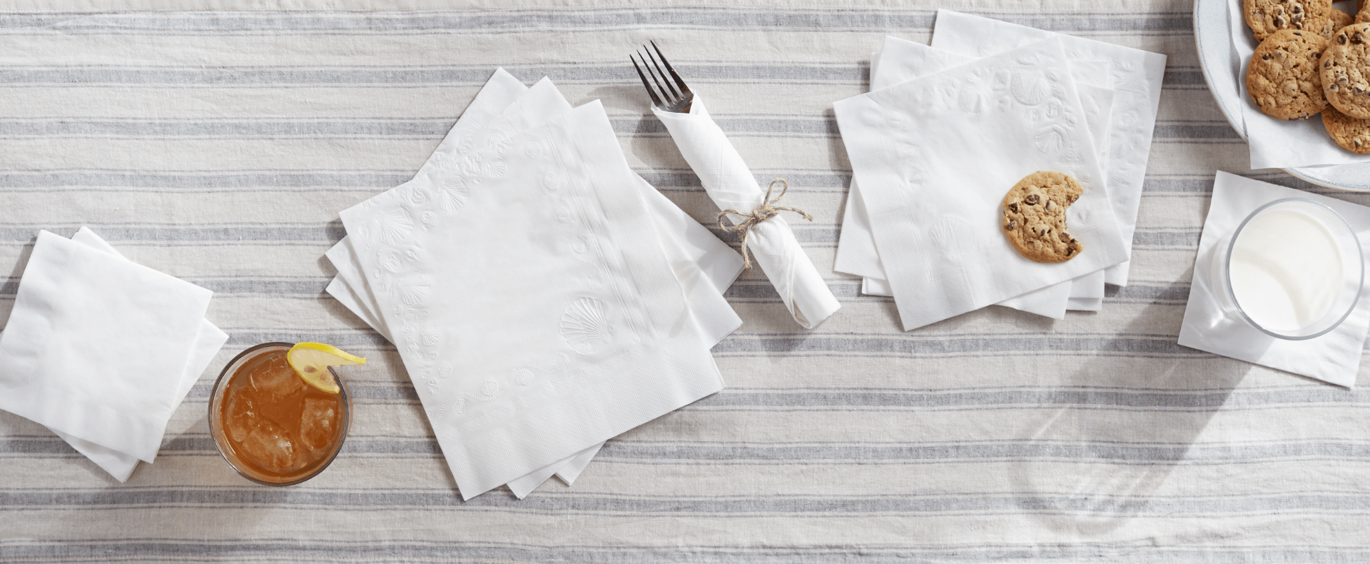 Vanity Fair Napkins spread across a table with cookies and tea.