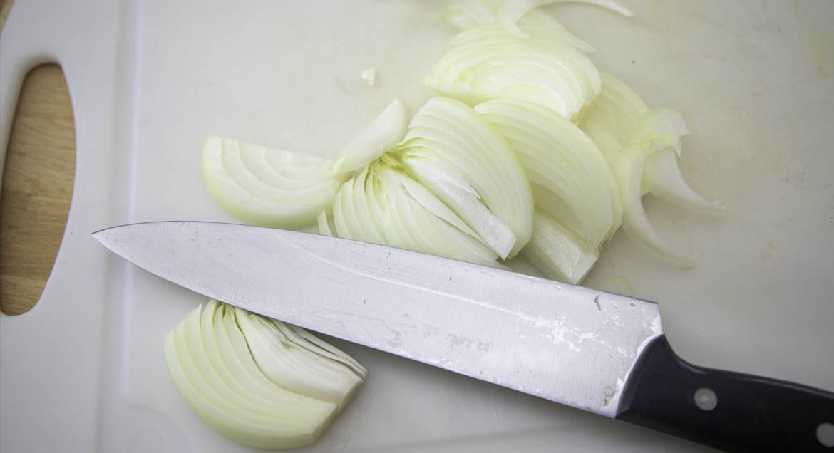 Sliced White Onion On Cutting Board.