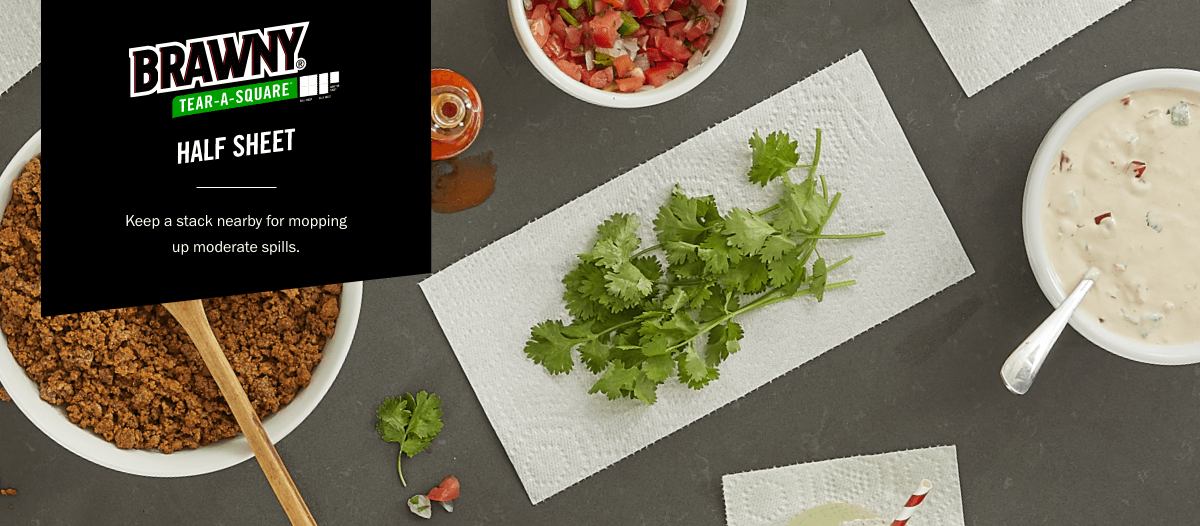 A view of a table with Brawny paper towels being used to dry cilantro.