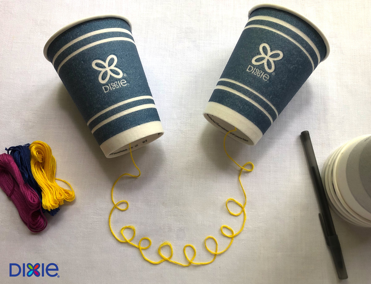 Two Dixie Cups Linked With String To Play Telephone.