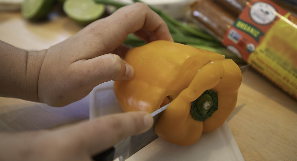 Chef Removes Seeds From Orange Bell Pepper To Make Tofu Sofrita Tacos.