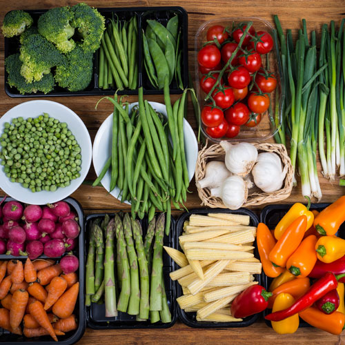 Assorted vegetables in colorful display.